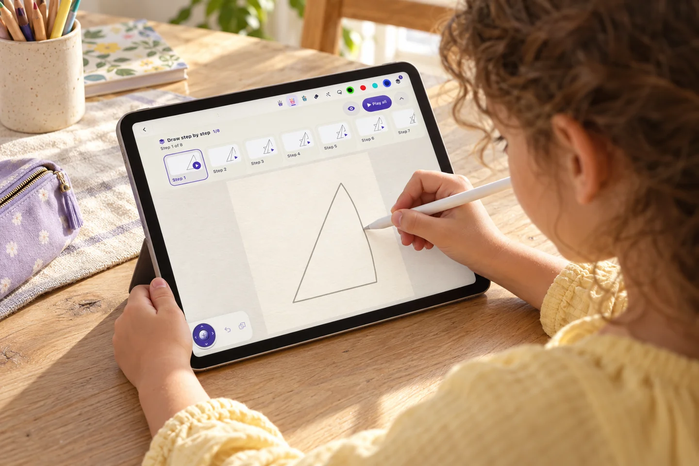 A child drawing along on an iPad with Apple Pencil